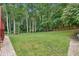 Expansive backyard featuring a lush lawn, mature trees, and a serene setting at 1438 Salem Dr, Alpharetta, GA 30009