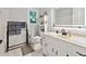 Well lit full bathroom with sleek fixtures, white cabinets, hexagon tile and a modern backlit mirror at 1438 Salem Dr, Alpharetta, GA 30009