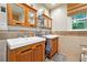 Bathroom featuring dual sinks, wood cabinetry, and tile flooring at 1438 Salem Dr, Alpharetta, GA 30009