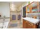Bathroom featuring bathtub, shower, and wooden cabinets at 1438 Salem Dr, Alpharetta, GA 30009