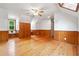 Bright bonus room with gleaming hardwood floors and warm wood paneling at 1438 Salem Dr, Alpharetta, GA 30009
