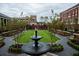 Beautiful courtyard featuring a tiered fountain, manicured lawn, and classic architecture at 1438 Salem Dr, Alpharetta, GA 30009