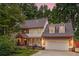 Charming two-story home with a covered porch, attached two-car garage, and lush landscaping at 1438 Salem Dr, Alpharetta, GA 30009