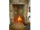 Stone fireplace with a log burning fire evokes a feeling of warmth at 1438 Salem Dr, Alpharetta, GA 30009