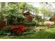 Charming two-story home featuring a beautiful landscaped yard with colorful flowerbeds and mature trees at 1438 Salem Dr, Alpharetta, GA 30009