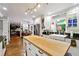 Open kitchen featuring an island with a butcher block countertop, stainless appliances, and seamless flow to living area at 1438 Salem Dr, Alpharetta, GA 30009