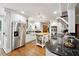 Bright kitchen featuring white cabinets, stainless steel appliances, island, and wood floors at 1438 Salem Dr, Alpharetta, GA 30009