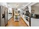 Bright kitchen with white cabinets, stainless steel appliances, and a functional island with a butcher block countertop at 1438 Salem Dr, Alpharetta, GA 30009