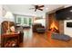 Cozy living room featuring a stone fireplace, hardwood floors, and natural light at 1438 Salem Dr, Alpharetta, GA 30009