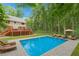 Beautiful backyard with a private in-ground pool, deck, lawn furniture and surrounding mature trees at 1438 Salem Dr, Alpharetta, GA 30009