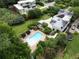 Aerial view of a luxurious home with a sparkling pool, beautifully landscaped yard, and modern architectural design at 1656 N Pelham Ne Rd, Atlanta, GA 30324