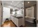 Bright bathroom with dual sinks, sleek fixtures, glass block window, and a luxurious soaking tub at 1656 N Pelham Ne Rd, Atlanta, GA 30324