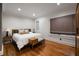 Comfortable bedroom featuring hardwood floors, a bed with soft linens, and stylish side tables with lamps at 1656 N Pelham Ne Rd, Atlanta, GA 30324
