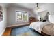 Cozy bedroom with a window view, hardwood floors, and built-in shelving, adjacent to a comfortable office space at 1656 N Pelham Ne Rd, Atlanta, GA 30324