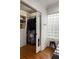 A well-organized closet with built-in shelving and hanging rods, complemented by a unique glass block window at 1656 N Pelham Ne Rd, Atlanta, GA 30324