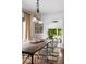 Stylish dining room with a rustic wooden table, clear chairs, and modern lighting fixtures for elegant dining at 1656 N Pelham Ne Rd, Atlanta, GA 30324