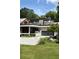 Modern exterior features a spacious driveway, landscaped yard, a covered patio, and a glass-paneled garage at 1656 N Pelham Ne Rd, Atlanta, GA 30324