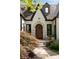 Close up of a home entrance with stone walkway leading to an arched wooden door at 1656 N Pelham Ne Rd, Atlanta, GA 30324