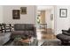 Cozy living room features a grey sofa, artwork, and a round glass coffee table, creating an inviting space at 1656 N Pelham Ne Rd, Atlanta, GA 30324