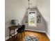 Attic office with desk and comfortable chair, natural light, hardwood floors, and built-in shelving at 1656 N Pelham Ne Rd, Atlanta, GA 30324