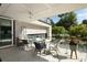 Covered outdoor patio featuring modern design, ceiling fan, and comfortable lounge furniture at 1656 N Pelham Ne Rd, Atlanta, GA 30324