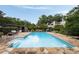 Gorgeous backyard pool with stone surround, poolside furniture, and lush landscaping at 1656 N Pelham Ne Rd, Atlanta, GA 30324