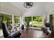 Serene sunroom with large windows and lush greenery offers a peaceful retreat with natural light at 1656 N Pelham Ne Rd, Atlanta, GA 30324