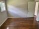 This bedroom features hardwood floors, a window with natural light, and neutral-colored walls at 5114 Rock Eagle Dr, Stone Mountain, GA 30083