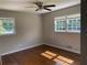 Simple bedroom with hardwood floors and two windows with exterior views, ideal for customization at 5114 Rock Eagle Dr, Stone Mountain, GA 30083