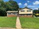 Charming two-story home with a lush green lawn and inviting curb appeal under a partly cloudy sky at 5114 Rock Eagle Dr, Stone Mountain, GA 30083