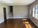 Bright living room with hardwood floors, natural light, and staircase entrance at 5114 Rock Eagle Dr, Stone Mountain, GA 30083