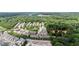 This aerial view shows townhomes nestled in a tree-filled suburban neighborhood at 1004 Bayrose Cir, East Point, GA 30344