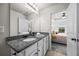 Bright bathroom featuring a granite countertop vanity adjacent to the bedroom at 1004 Bayrose Cir, East Point, GA 30344