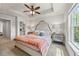 A well-lit bedroom features a tray ceiling and a stylish upholstered headboard at 1004 Bayrose Cir, East Point, GA 30344