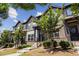 Attractive townhomes with brick and siding, complemented by lush green lawns and decorative trees at 1004 Bayrose Cir, East Point, GA 30344