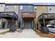 This townhome features a back porch, gray garage, and exterior storage space at 1004 Bayrose Cir, East Point, GA 30344