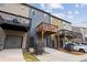 This townhome features a back porch, gray garage, and exterior storage space at 1004 Bayrose Cir, East Point, GA 30344
