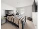 This bedroom is well-lit with a large bed, TV, and neutral color scheme at 11640 Mendenhall Ct, Hampton, GA 30228
