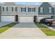 Charming townhome exterior with attached garages and a neatly maintained front lawn in a vibrant community at 11640 Mendenhall Ct, Hampton, GA 30228