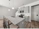 Modern kitchen with granite countertops, stainless steel appliances, and ample seating at the island at 11640 Mendenhall Ct, Hampton, GA 30228