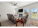 Cozy living room with fireplace, ceiling fan, and sliding doors that bring in light at 11640 Mendenhall Ct, Hampton, GA 30228