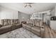 Bright, modern living room with hardwood floors, neutral paint, and an open view of the kitchen at 11640 Mendenhall Ct, Hampton, GA 30228