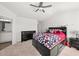Spacious main bedroom with ceiling fan, carpet, and en suite bathroom at 11640 Mendenhall Ct, Hampton, GA 30228