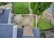 A view of a patio with an umbrella in a quaint backyard surrounded by lush greenery and a white picket fence at 563 Trillum Sw Ct # 563, Marietta, GA 30008