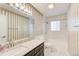 Well-lit bathroom with marble countertops, updated fixtures, and a shower-tub combination at 563 Trillum Sw Ct # 563, Marietta, GA 30008