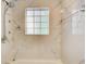 Updated bathroom featuring marbled tile shower with sleek fixtures and natural light from a window at 563 Trillum Sw Ct # 563, Marietta, GA 30008