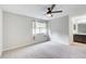 This bedroom features neutral walls, plush carpet, natural light from a window, and ceiling fan at 563 Trillum Sw Ct # 563, Marietta, GA 30008