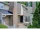 Inviting townhome exterior featuring a brick chimney, fenced patio with umbrella, and well-maintained siding at 563 Trillum Sw Ct # 563, Marietta, GA 30008