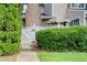 Charming townhome featuring a brick chimney and a lovely fenced front yard with lush greenery at 563 Trillum Sw Ct # 563, Marietta, GA 30008