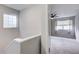 Hallway with natural light and neutral tones leading into a carpeted bedroom with a window and ceiling fan at 563 Trillum Sw Ct # 563, Marietta, GA 30008